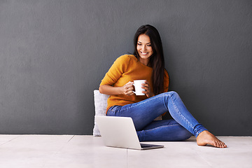 Image showing Laptop, search and happy woman on a floor with coffee for streaming, reading or movie on wall background. Computer, mockup or female person online for google it, menu or Netflix and chill sign up