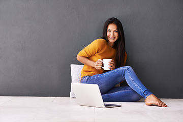 Image showing Woman, laptop and portrait or cup in home, website and coffee or tea on floor of living room. Female person, mockup space and wall background for freelancer, plan and remote work in apartment on app