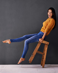 Image showing Woman, smile and portrait on chair for clothes, trend and style for fashion and bold color for weekend. Female person, model and happy with jersey for casual outfit, stylish and fashionable on mockup