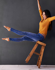 Image showing Happy, chair and excited with woman in studio for news, announcement and balance. Happiness, winner and mockup space with female person on wall background for success, celebration and energy