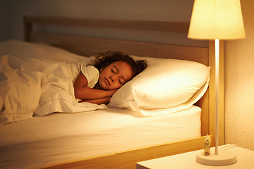 Image showing Girl, sleeping and peace in bed at night, comfortable and tired or dream on pillow in home. Female person, child and resting in bedroom or lying to relax, exhausted and fatigue or peace and calm