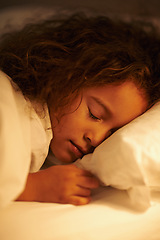 Image showing Girl, sleeping and dream in bed at night, comfortable and tired or bedtime on pillow in home. Female person, child and resting in bedroom or lying to relax, exhausted and fatigue or peace in closeup