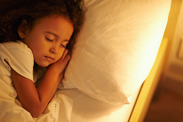 Image showing Child, sleeping and peace in bed at night, comfortable and tired or dream on pillow in home. Female person, girl and resting in bedroom or lying to relax, exhausted and fatigue or blanket for calm