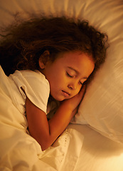 Image showing Child, sleeping and top view in bed at night, comfortable and tired or dream on pillow in home. Female person, girl and resting in bedroom or lying to relax, exhausted and fatigue or peace and calm