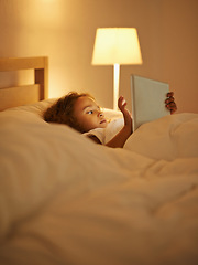 Image showing Internet, child and tablet in bed at night, comfortable and online for games or play in home. Female person, girl and rest in bedroom or lying to relax, website and streaming or app for entertainment