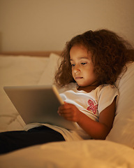 Image showing App, child and tablet in bed at night, comfortable and online for games or playing in home. Female person, girl and movie in bedroom or lying to relax, website and internet or streaming entertainment