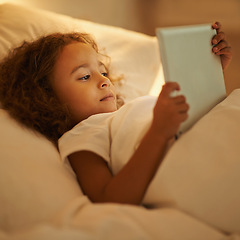 Image showing Bedtime, child and tablet in bed at night, comfortable and online for games or play in home. Female person, girl and rest in bedroom or closeup to relax, website and internet or app for entertainment