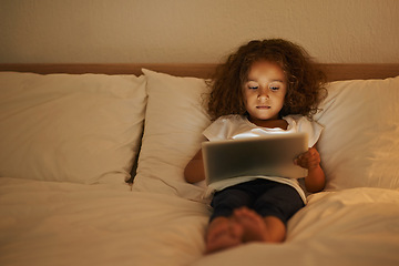 Image showing Streaming, child and tablet in bed at night, comfortable and online for games or playing in home. Female person, girl and reading in bedroom to relax, website and internet or app for entertainment