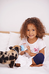 Image showing Child, piglet and feeding bottle for portrait in home, pet care and liquid nutrition on bed in bedroom. Female person, girl and learn responsibility in childhood, love and food for animal or formula