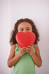 Image showing Girl, child and portrait with heart for love in home, emoji and peace or kindness aesthetic with icon. Female person, valentines day and review or opinion by white background, compassion and care