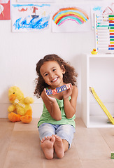 Image showing Girl, portrait and learning alphabet with blocks in home, child development and growth with letters. Female person, kid and abc on floor for language, bedroom and creative game for education with toy