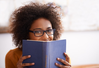 Image showing Portrait, black woman and reading book in living room to relax for literature, leisure and hobby in home. Happy, education and face of female student for learning, knowledge and information