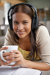 Image showing Music, coffee and woman relax with a book on sofa in home on holiday, reading with a drink and happiness. Girl, smile and hearing sound from headphones on couch with free audio, novel and enjoy tea