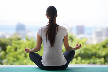 Image showing Woman, meditation and yoga with mat for workout, exercise or spiritual wellness by window at home. Rear view of female person or yogi meditating in relax for inner peace, zen or fitness at the house