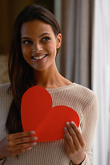 Image showing Woman, smile and heart paper for kindness, care and love emoji for valentines day in home. Female person, happy and romance aesthetic or review and opinion, shape and icon for peace or compassion