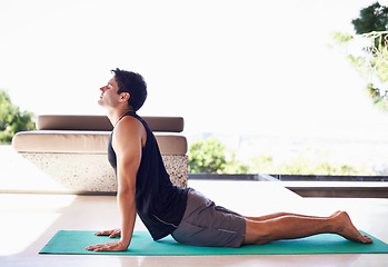 Image showing Yoga, fitness and breathing with man in cobra pose for self care, aura and balance in workout at home. Calm, zen and fresh air outdoor, stretching and flexible with exercise for health and wellness