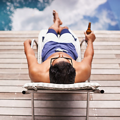 Image showing Man, relax and beer at pool in summer at hotel, resort or travel to luxury villa with peace in Florida. Calm, holiday and glass of alcohol in hand on deck at poolside in Miami with hospitality