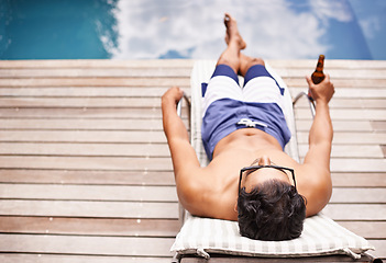 Image showing Man, relax and beer at pool in summer at hotel, resort or luxury vacation at villa with peace in Florida. Calm, holiday and glass of alcohol in hand on deck at poolside in Miami for travel mockup
