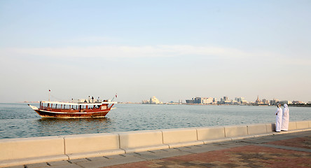 Image showing Doha Corniche locals and boat