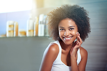 Image showing African woman, portrait and facial cream with smile, wellness or afro in home bathroom for morning routine. Girl, person and serum with cosmetics, beauty and transformation with skincare in apartment