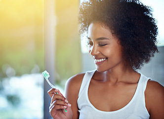 Image showing African woman, toothbrush and smile in bathroom for oral wellness, health and benefits for mouth in home. Girl, person and teeth whitening with product, cleaning and toothpaste for results in house