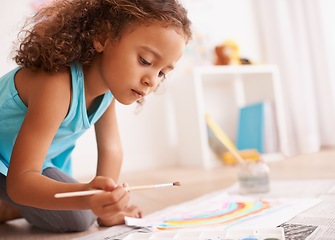 Image showing Education, kindergarten or girl painting a rainbow on classroom floor for creative, learning or child development. Paper, color splash or cute kid with school art paint, sketch or having fun drawing