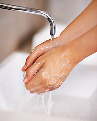 Image showing Hands, water and soap for person cleaning in skincare, routine and grooming in home closeup. Bathroom, tap and washing skin with foam for sanitary protection of hygiene from germs, bacteria and virus