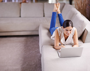 Image showing Laptop, relax and social media with woman on sofa in living room of apartment for research or browsing. Computer, internet and technology with person typing email, report or article for online blog