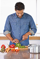 Image showing Cooking, man and cutting vegetables on kitchen counter for healthy diet, nutrition or lunch. Chopping board, food and vegan person preparing salad for dinner, meal and organic ingredients in home