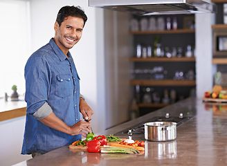 Image showing Cooking, portrait and happy man chopping vegetables on kitchen counter for healthy diet, nutrition or lunch. Cutting knife, food and face of person preparing fresh salad for organic meal in home