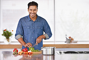Image showing Cooking, portrait and happy man cutting vegetables on kitchen counter for healthy diet, nutrition or lunch. Chopping board, food and face of person preparing fresh salad for organic meal prep in home