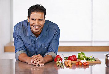 Image showing Man, smile and vegetables in kitchen for food, cooking and recipe for health indoor on mockup. Nutritionist or vegan with carrot, pepper and tomatoes with garlic for ingredient and vitamin