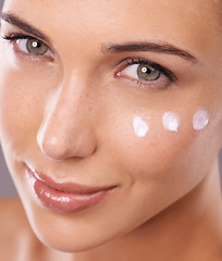 Image showing Face, cream and skincare with woman in portrait in studio, moisturizer and dermatology for beauty. Skin health, cosmetic product with sunscreen or lotion dots, facial treatment or salon for antiaging