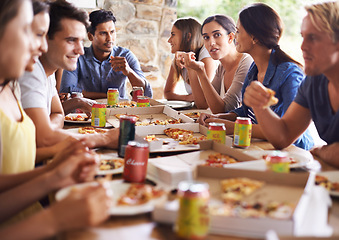Image showing Friends, group and eating of pizza in house with happiness, soda and social gathering for bonding in backyard. Men, women and fast food with smile, drinks and diversity at table in lounge of home