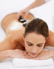 Image showing Relax, hot stone massage and woman at spa for health, wellness and luxury holistic treatment. Self care, peace and girl with natural body therapy, comfort and calm pamper service with hotel therapist