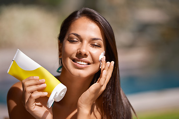 Image showing Woman, swimming pool and sunscreen protection on face or summer weekend or tanning, holiday or wellness. Female person, product and skincare health or dermatology cream in Hawaii, self care or travel