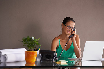 Image showing Phone call, remote work and landline with receptionist woman in office for communication or reception. Laptop, smile and happy young woman answering telephone in small business or startup workplace