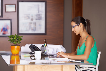 Image showing Business woman, planning and typing on computer for email, research and real estate website in work from home office. Architecture worker, realtor or freelancer on laptop for floor plan or blueprint