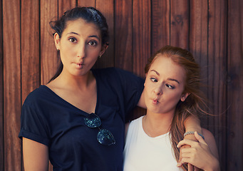 Image showing Portrait, funny face and best friends on wooden background together for bonding or relationship. Love, goofy or silly and happy young women having fun with fashion in summer for holiday and vacation