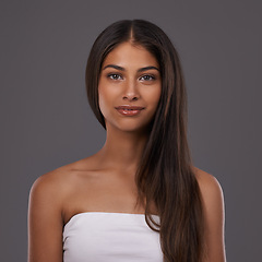 Image showing Hair care, portrait and woman with beauty, skincare or shine isolated on a gray studio background. Hairstyle, cosmetics or face of Indian model in makeup at salon for treatment or glow at hairdresser