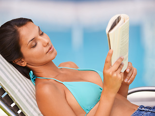 Image showing Woman, bikini and swimming pool relax or reading book for holiday vacation at hotel accommodation, summer or resting. Female person, swimwear and Hawaii trip for travel resort, tanning or peaceful