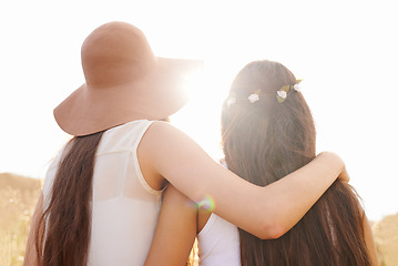 Image showing Friends, hug and walking in summer nature on holiday or journey on vacation for adventure. Women, back and embrace outdoor together in sunshine on field, trekking on hill or travel environment