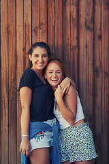 Image showing Portrait, smile and woman friends on wooden background together for bonding or relationship. Love, funny or laughing and happy young people having fun with fashion in summer for holiday and vacation