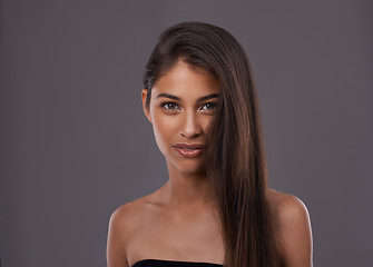 Image showing Portrait, hair care and beauty of woman in makeup, glow or shine isolated on gray studio background. Face, hairstyle and Indian model in cosmetics at salon for skincare at hairdresser on mockup space