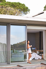 Image showing Woman, balcony and bedroom with coffee on pajamas in morning, fresh and healthy at home in Los Angeles. Glass door, female person and happy with thoughts to relax for leisure, comfort and enjoy.