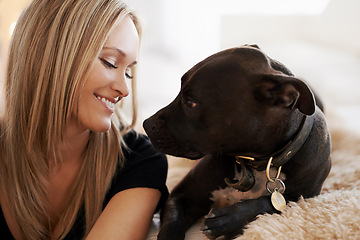 Image showing Smile, love or woman and dog on a sofa with trust, care and bonding at home together. Pets, face and female person relax with pitbull puppy in a living room with security, protection or foster safety