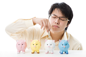 Image showing Asian businessman saving money