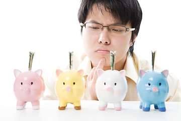 Image showing Asian businessman saving money