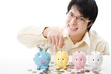 Image showing Asian businessman saving money