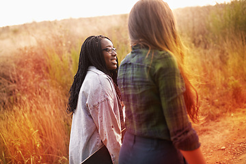 Image showing Friends, hiking and happy journey in nature on holiday or vacation in summer, countryside and mountain. Women, walking and relax outdoor together on trail, trekking on hill and travel environment